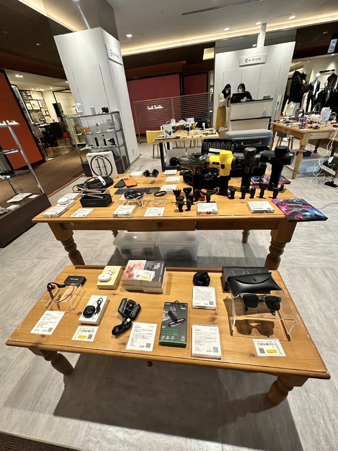 東京・有楽町のGloture ポップアップストアで、木のテーブルに並ぶガジェットやライフスタイル製品。